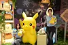 People hold plush toys of Pokemon at Lotte Department Store branch in Busan on July 20.