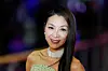 Michelle Yeoh smiles on a film festival red carpet in a strapless gown and diamond necklace.