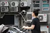 A person walks in front of building where outdoor units of air conditioning device are installed in Seoul on Aug. 9.