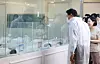 Seoul Mayor Oh Se-hoon, left, looks newborn babies at the city-managed postpartum nursery in western Seoul on Aug. 3.