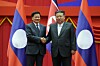 North Korean leader Kim Jong-un, left, shakes hands with Laos President Thongloun Sisoulith in North Korea on Oct. 7, 2025, in a photo carried by Rodong Sinmun.