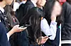 Students use smartphones after their school hours in Seoul on Nov. 4, 2024.