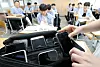 A student submits a smartphone device in a high school in Daejeon on Sept. 1, 2023.