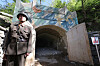 A North Korean official guards an entrance to the Punggye-ri underground nuclear test site in North Hamgyong Province in May 2018.