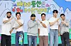 Six cast members and producers pose onstage beneath a colorful Korean Netflix series backdrop.