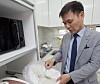 Kim Chang-wan pours rice in a free-dormitory operated in his apartment in Incheon in an undated photo.