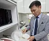 Kim Chang-wan pours rice in a free-dormitory operated in his apartment in Incheon in an undated photo.