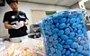 Illegally produced Viagra pills are seen in a glass jar at a state-run food safety institution in western Seoul on June 4, 2024.