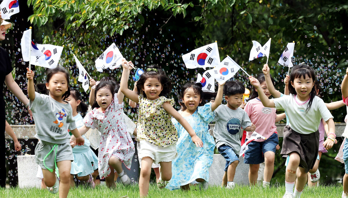 Daycare children wave Taegeukgi Korean national flags ahead of Liberation Day at Chonnam National University in Gwangju