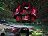 Central arena screens display Faker branding above a brightly lit esports stage and audience.