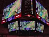 Suspended arena scoreboard showing game footage, graphics, and FanDuel branding.