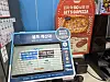 Touchscreen lottery kiosk with Korean text beside a red GoPizza pizza advertisement.