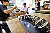 Sliced gimbap arranged on a black platter at a busy Seoul restaurant.