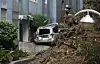 A car is half-buried by soil and debris from a landslide in Geoje, South Gyeongsang, on Aug. 17.