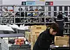 Workers classify delivery products for orders at a supermarket in central Seoul on Feb. 9.