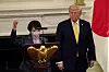 Japanese Prime Minister Sanae Takaichi, left, raises her fist while saying 'Japan is back' as she delivers remarks during a dinner hosted by U.S. President Donald Trump at the White House in Washington on March 19.