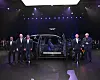 Hyundai Motor Group Executive Chair Euisun Chung, second from left, Hyundai Motor CEO Jose Munoz, third from left, and other executives pose with the newly unveiled GV90 at at the Palace of Fine Arts in San Francisco on Aug. 19.