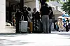 Foreign tourists carrying their suitcases are seen in the Hong-dae neighborhood in western Seoul on Aug. 6.