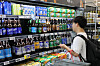 A shopper browses the liquor shelves at a supermarket in Seoul on Aug. 23. 2026