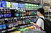 A shopper browses the liquor shelves at a supermarket in Seoul on Aug. 23. 2026