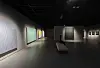 A person views abstract artworks in a dimly lit gallery at the Park Seo-Bo Museum in Seoul.