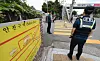 Police officers patrol outside an elementary school in Daegu as students head home after classes on Sept. 12, 2025.