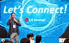 Presenter speaking to an audience before a blue LG Innotek event backdrop.