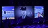 Blue-lit stage with a central portrait screen, side graphics, and a BICF poster.