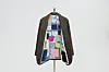 Dark coat with a colorful patchwork lining displayed on a stand against a light background.