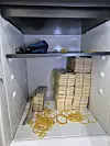 Bundles of 50,000-won ($36) bills are hidden inside a vault of the 35-year-old suspect