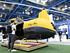 Yellow-and-black cargo robot helicopter on display at an EV exhibition in Seoul.