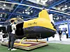Yellow-and-black cargo robot helicopter on display at an EV exhibition in Seoul.