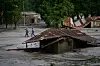 People walk amid damage in the aftermath of flash floods in Devighat in the Nuwakot district in Nepal, Thursday, Aug 27, 2026. (AP Photo/Niranjan Shrestha)