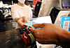 A customer makes a payment with their credit card at a restaurant in central Seoul on June 29, 2021.