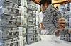 A person shows dollars at a Hana Bank in central Seoul on Dec. 17, 2025.