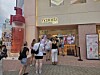 Shoppers gather outside a Yepoda skincare store beside a giant red product display.
