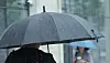 People walk with umbrellas in Gangnam District, southern Seoul, on July 9.
