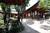 Traditional Seoul hanok courtyard with trees, gravel paths, and wooden exhibition rooms.