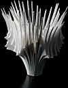 Abstract silver sculpture with layered pointed forms on a black background.