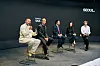 Five panelists sit on a Seoul stage as one man speaks into a microphone.