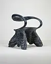 Textured black abstract animal-like sculpture on a white background.