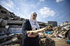 Manuscript conservator Haneen Al-Amassi collects documentary materials from the rubble of a site destroyed in an airstrike in Gaza.