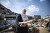 Manuscript conservator Haneen Al-Amassi collects documentary materials from the rubble of a site destroyed in an airstrike in Gaza.