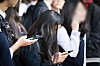 Middle school students are seen using their smartphone devices in Seoul on Nov. 4, 2024.