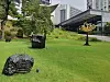 Outdoor sculptures by artists Lee on a grassy lawn beside a modern building.