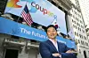 Coupang Founder Bom Kim poses in front of the New York Stock Exchange facade before his company's public listing on March 11, 2021.