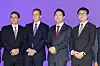 Four suited officials and art fair executives pose before a purple backdrop at COEX in Seoul.