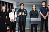 Curator Ruan Yuanlai speaks at a press conference with four people standing beside him.