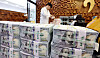 Bundles of dollars are piled up at Hana Bank in central Seoul on Aug. 5.