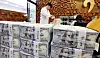 Bundles of dollars are piled up at Hana Bank in central Seoul on Aug. 5.